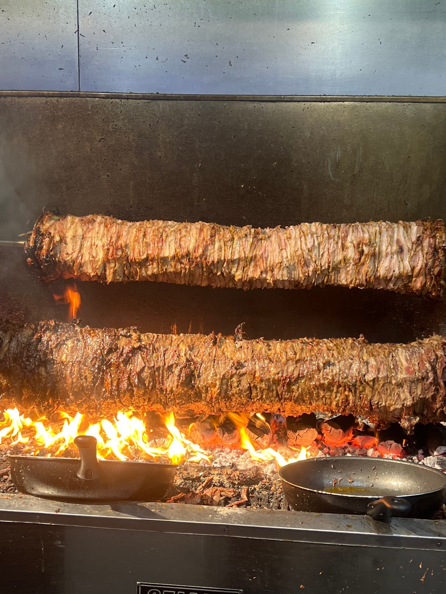Charcoal grill setup at Bayside Souvlaki Cafe