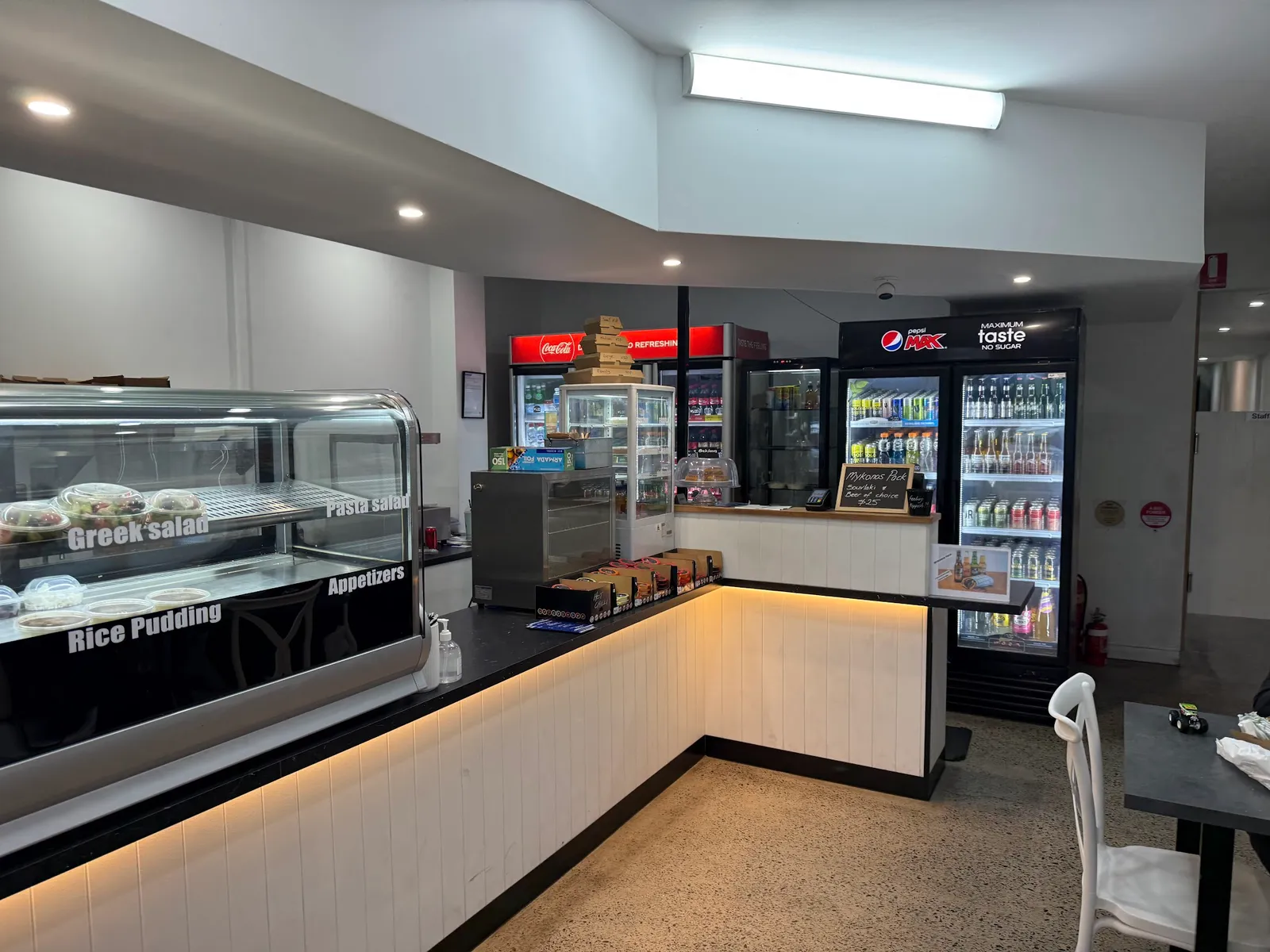 Bayside Souvlaki Cafe counter area with deli display, illuminated bench and drink fridges