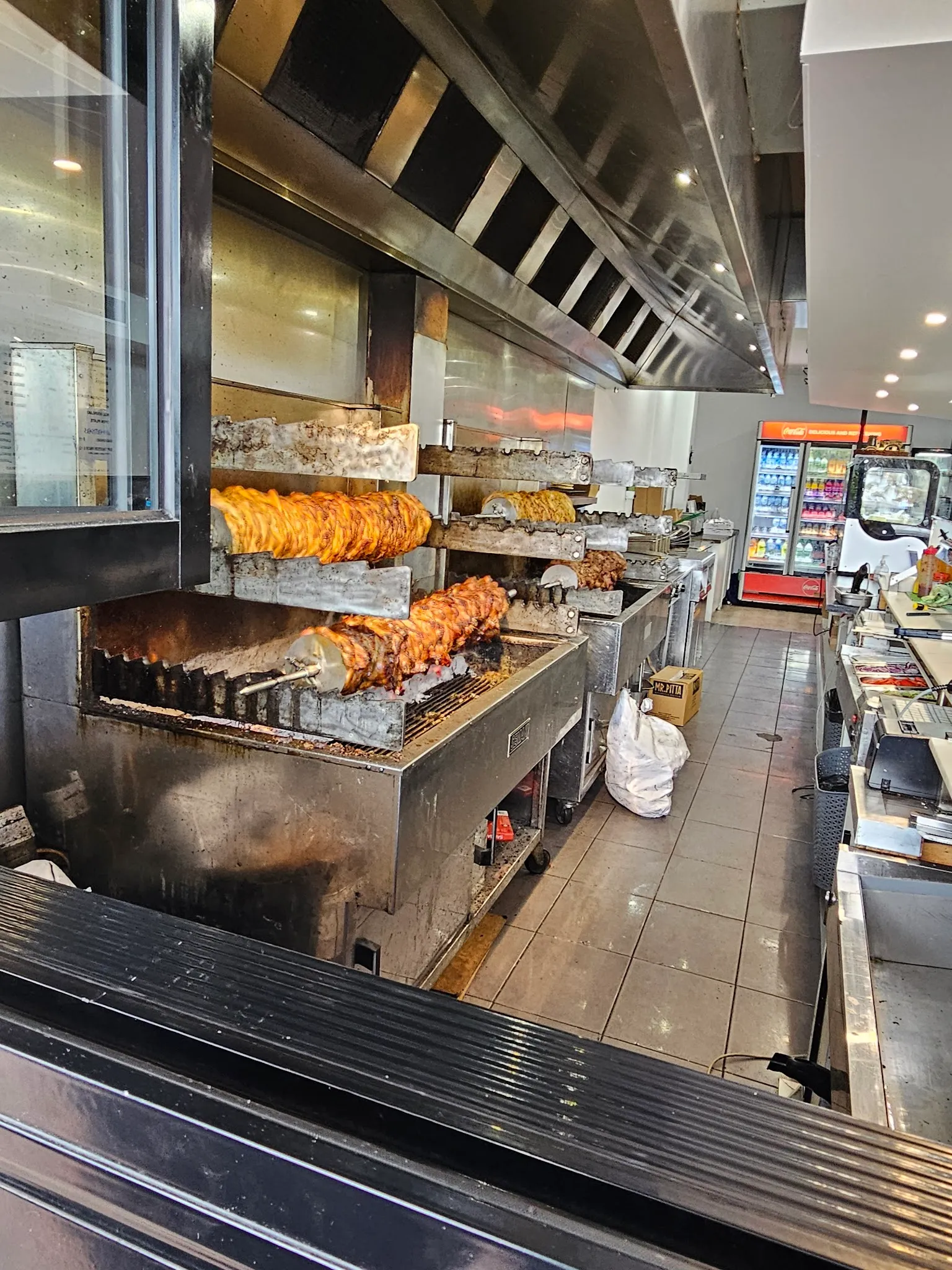 Close-up of souvlaki being assembled at the counter